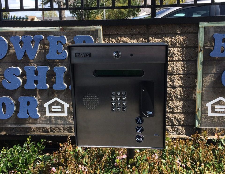 Access control keypad and intercom panel mounted at a gated property entrance