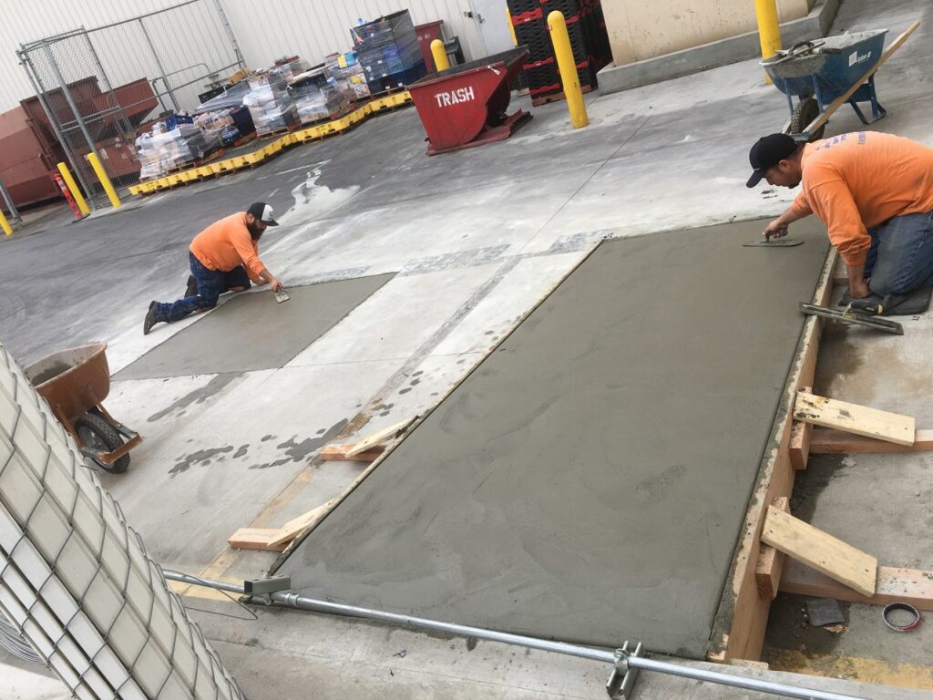 Lobby Traffic Systems installation crew finishing concrete work at a commercial facility
