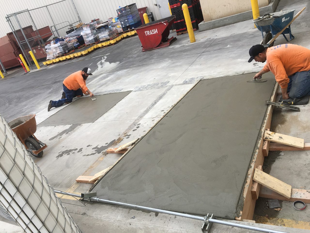 Lobby Traffic Systems installation crew finishing concrete work at a commercial facility
