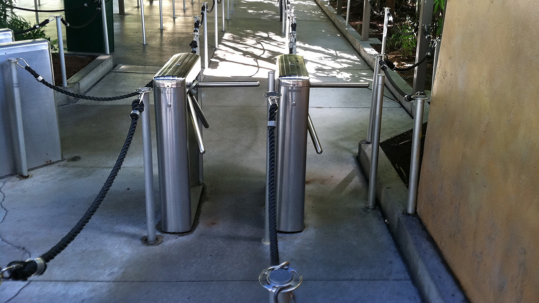 Rope stanchion queue line leading to waist-high turnstiles