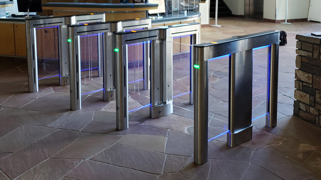 Modern optical turnstiles with LED indicators in a building lobby entrance