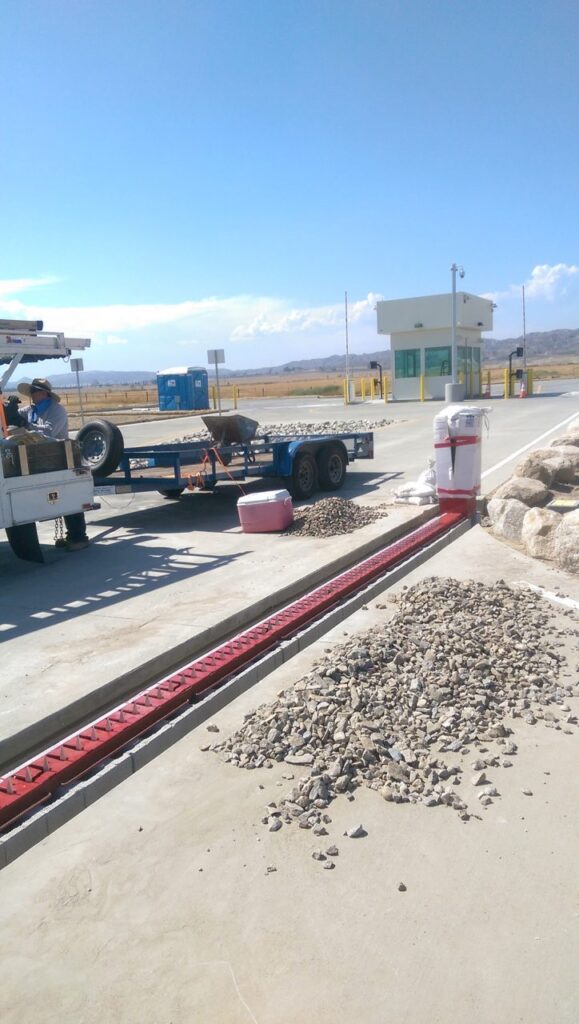 Guard booth and traffic spikes controlling a secured vehicle checkpoint